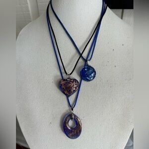 Three blue vibe glass pendant necklaces on satin cord